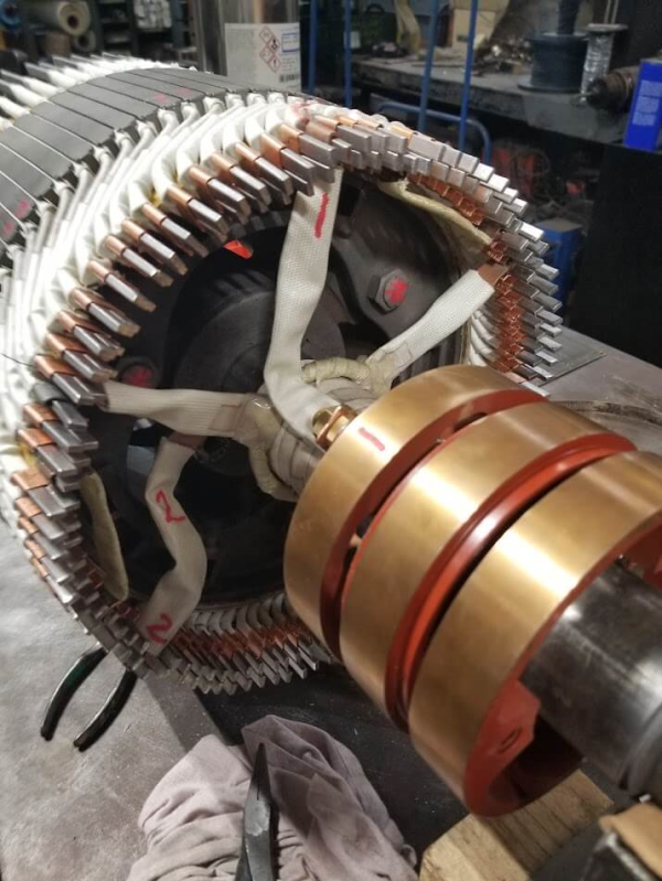 Skilled technicians performing DC motor repairs